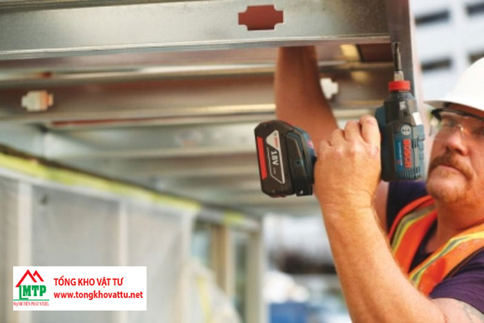 Đục lỗ để lắp các thanh sắt thành hệ khung cố định với tường